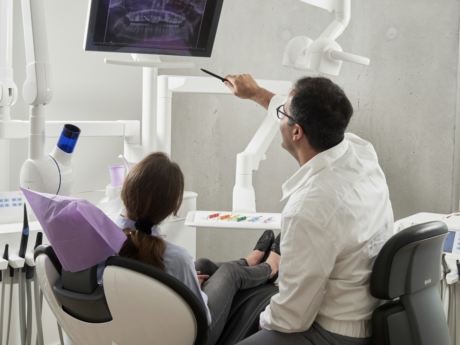Dentist discussing a panoramic X-ray with a patient